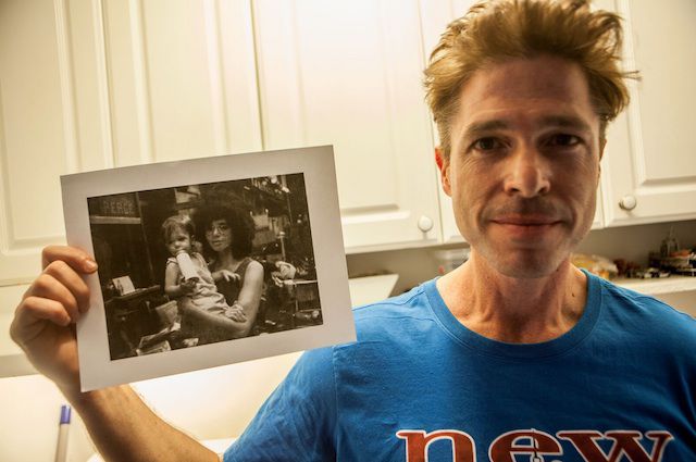 B.A. holding a photo of himself and his mother in Greenwich Village